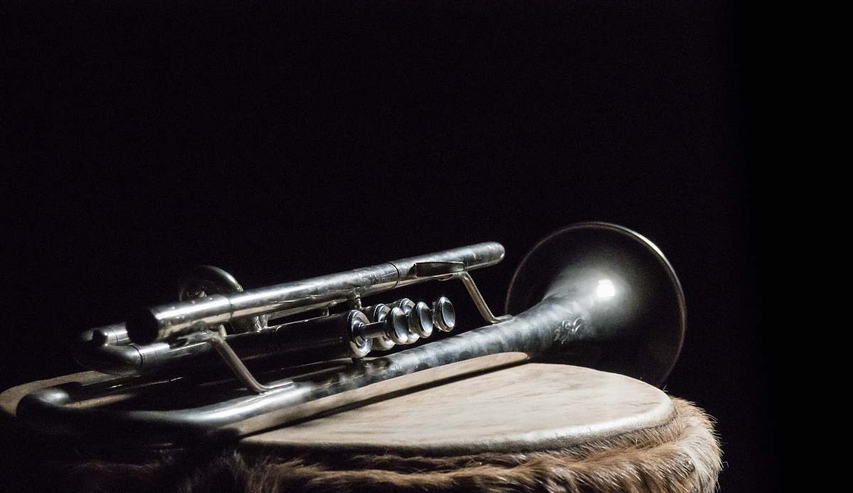 musical instrument silver trumpet on brown wooden surface trumpet
